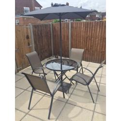 Garden table and 4 chairs brand new with parasol