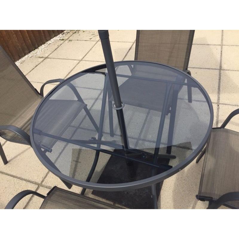 Garden table and 4 chairs brand new with parasol