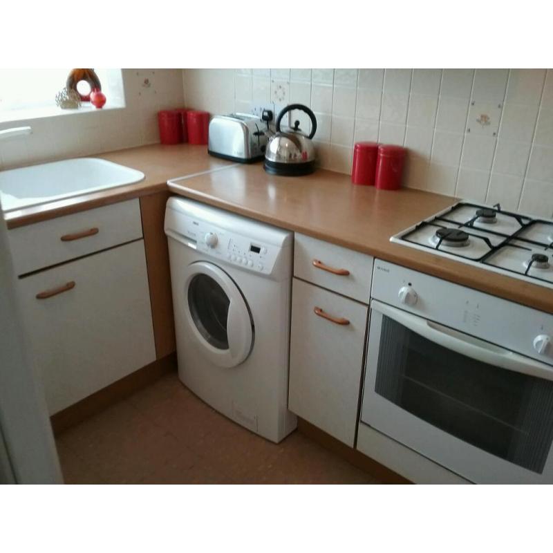 Kitchen units with hob, oven, extractor fan and white composite sink