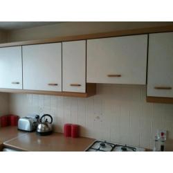 Kitchen units with hob, oven, extractor fan and white composite sink