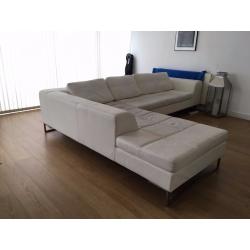 White faux leather, left hand corner couch. DWELL