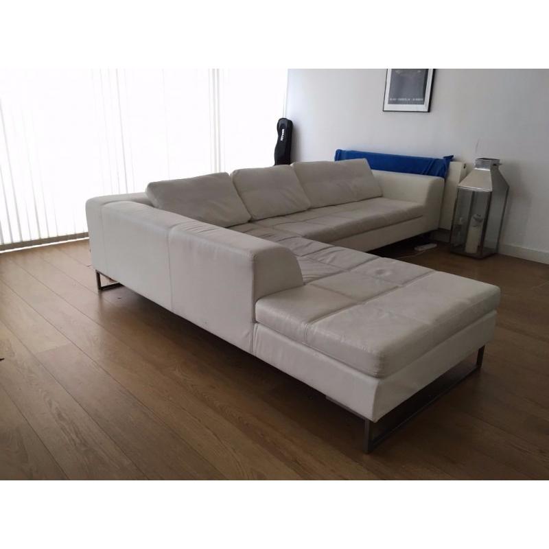 White faux leather, left hand corner couch. DWELL