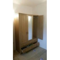 1 three door wardrobe with mirror & four draws. Not flat packed in immaculate condition. QUICK SALE