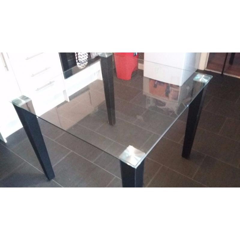 lovely glass kitchen table with black legs.